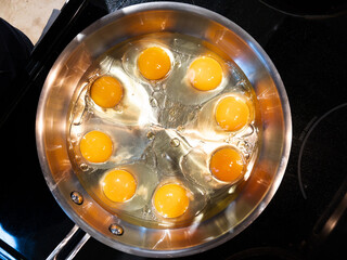 Egg yolks in a frying pan on the stove