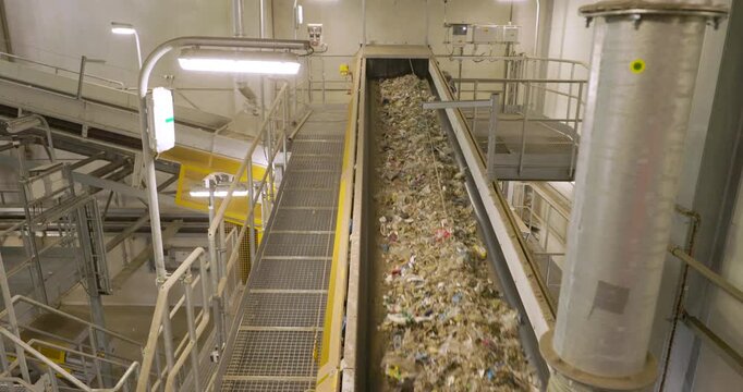 Refuse-Derived Fuel (RDF) on Conveyor Belt in Recycling Facility - Sustainable Waste Management and renewable energy production.