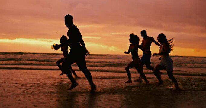 Silhouette, ocean and friends running at sunset for summer vacation, holiday and travel together outdoor. Beach, dusk and group of people at sea water for adventure, party and having fun in nature