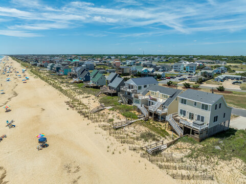 Aerial view of colorful beach front vacation rental properties in the outer banks with beach access, pool, patio, prime American vacation destination