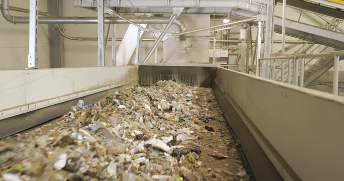 Refuse-Derived Fuel (RDF) on Conveyor Belt in Recycling Facility - Sustainable Waste Management and renewable energy production.