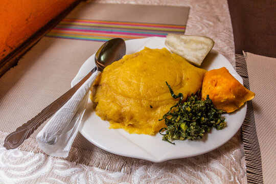 Lunch in Uganda - matoke (mashed plantains), tubers and sukuma