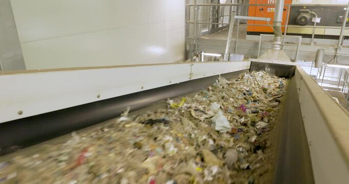 Refuse-Derived Fuel (RDF) on Conveyor Belt in Recycling Facility - Sustainable Waste Management and renewable energy production.