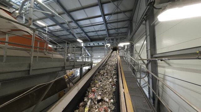 Refuse-Derived Fuel (RDF) on Conveyor Belt in Recycling Facility - Sustainable Waste Management and renewable energy production.