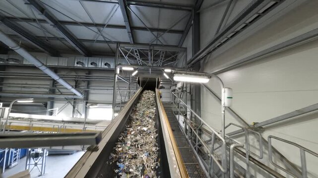 Refuse-Derived Fuel (RDF) on Conveyor Belt in Recycling Facility - Sustainable Waste Management and renewable energy production.