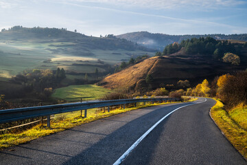 Highway in mountains in autumn evening