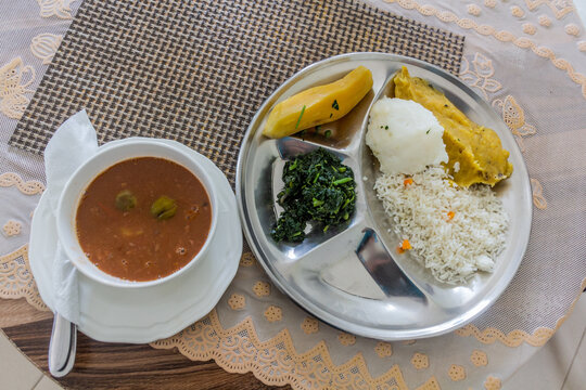 Lunch in Uganda - bean soup with matoke (mashed plantains), rice, posho (corn meal) and sukuma