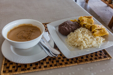 Meal in Uganda - groundnut (peanut) sauce, rice, chapati and posho corn meal