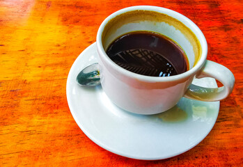 Cup of americano black coffee in restaurant cafe in Mexico.