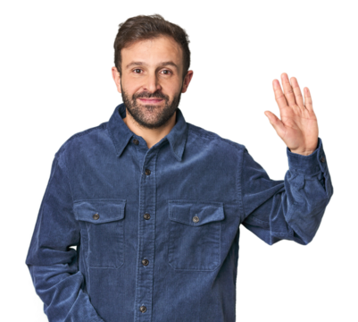Studio portrait of young Hispanic male smiling cheerful showing number five with fingers.
