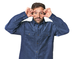 Studio portrait of young Hispanic male keeping eyes opened to find a success opportunity.