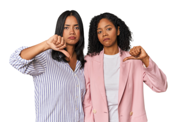 Young Latin businesswomen in studio showing a dislike gesture, thumbs down. Disagreement concept.
