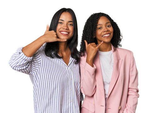 Young Latin businesswomen in studio showing a mobile phone call gesture with fingers.