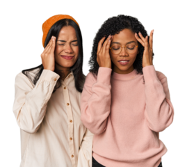 Young Latin friends together in studio touching temples and having headache.