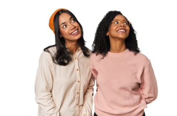 Young Latin friends together in studio relaxed and happy laughing, neck stretched showing teeth.