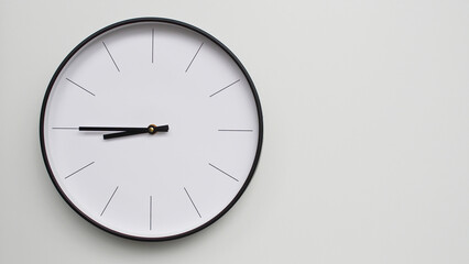 Wall Clock Showing 21.45/09.45 O'Clock on White Wooden Surface - Perfect for Time Management and Scheduling Concepts