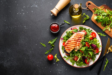 Dash diet plate. Chicken steak with fresh salad on black background. Top view with copy space.