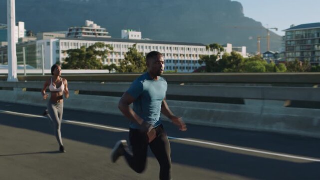 Fitness people, running and exercise in the city for workout, training or healthy cardio in the outdoors. Active man and women exercising having a run or race in a urban town street for endurance