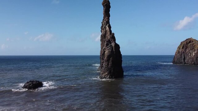 Drone footage of Ilheus da Ribeira da Janela, showcasing stunning coastal rock formations and a picturesque mountain village, ideal for travel, nature, and scenic landscape projects.