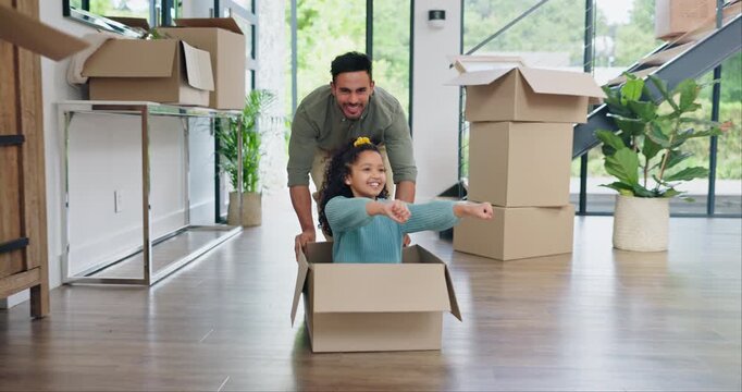 Happy dad, box and playing with girl in new home for real estate, bonding or property investment. Father pushing child with smile for fun playful relocation, renovation or moving in house together