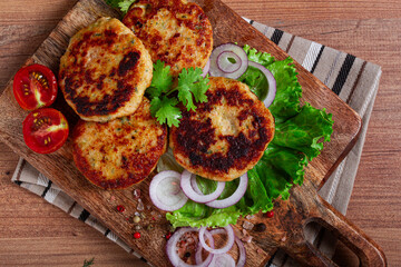fried chicken cutlets, minced chicken, with vegetables, on a cutting board, with vegetable salad, top view, homemade, no people,