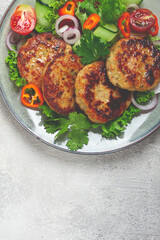 fried chicken cutlets, minced chicken, with vegetables, on gray , with vegetable salad, top view, homemade, no people,