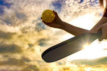 Pickleball serve against sunrise