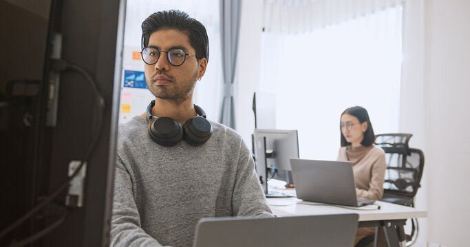 Young adult Asian male, female software developer coding program on desktop computer. Man, woman work from home, remote working, freelance programmer job, smart digital nomad lifestyle concept