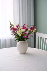 A Beautiful and Elegant Floral Arrangement Displayed in a Vase on a Table Surface