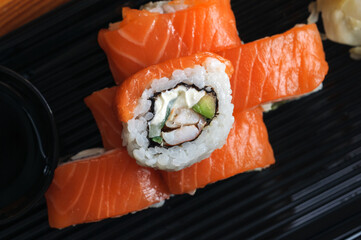 Sushi rolls with salmon, cucumber and avocado, top view, close-up, selective focus
