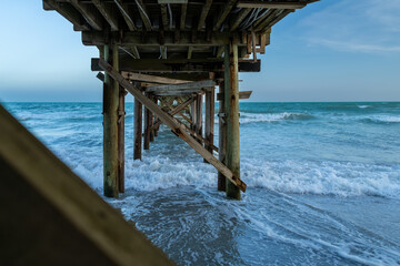 Wooden Pier Extending into Ocean Waves