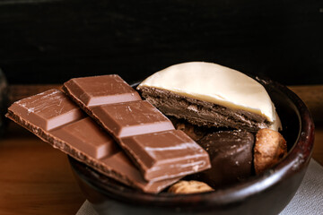 Chocolate chip cookies, dark and white chocolate bar, small bowl of oatmeal and nuts. International Chocolate Day.