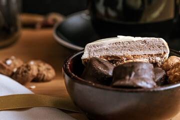 Chocolate chip cookies, dark and white chocolate bar, small bowl of oatmeal and nuts. International Chocolate Day.