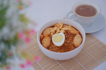 spicy egg noodle soup with crackers