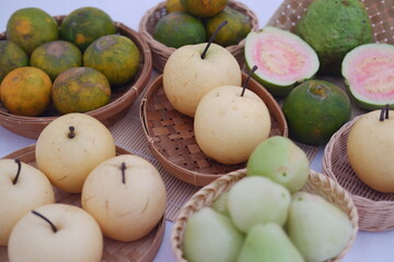 various kinds of fruit in basket on white background.