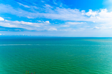 Obraz premium Blue sea with waves and beautifiull sky with clouds.