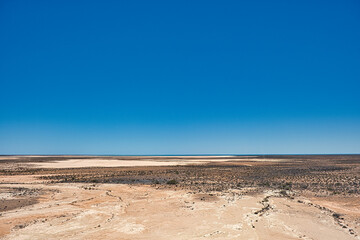 Featureless flat outback landscape between Wooramel and Overlander Roadhouse, Highway 1, Western Australia. Dried out lakes, in the distance Shark Bay
