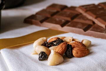 Chocolate chip cookies, dark and white chocolate bar, small bowl of oatmeal and nuts. International Chocolate Day.