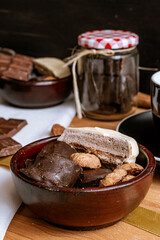 Chocolate chip cookies, dark and white chocolate bar, small bowl of oatmeal and nuts. International Chocolate Day.
