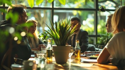  Business professionals are immersed in a discussion around a conference table adorned with plants