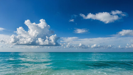 Obraz premium Beautiful expansive ocean view with clear blue sky and scattered white clouds on a sunny day.