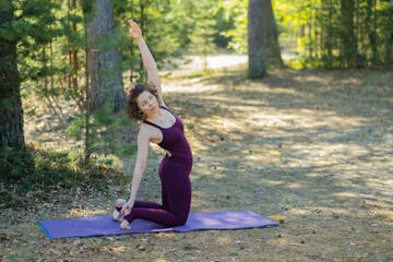 Young woman doing yoga outdoors in the park