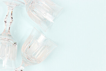 Vintage crystal glasses on a blue background. Concept with place for text.