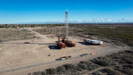Aerial view of drilling rig. Andes Nevada mountain range background.