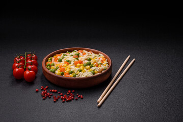 Delicious boiled rice with vegetables or risotto with carrots, peas and corn