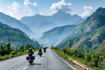 a group of people on motorcycles traveling along a road against a mountainous background