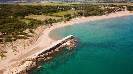 aerial view of the the Moll Grec, a historic stone wall at the beach of the Mediterranean Sea near l'Escala, Girona, Catalonia, Costa Brava, Spain