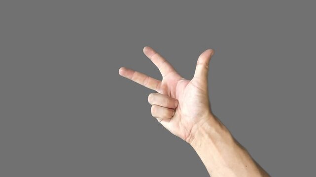 Hand on gray background, finger counting
