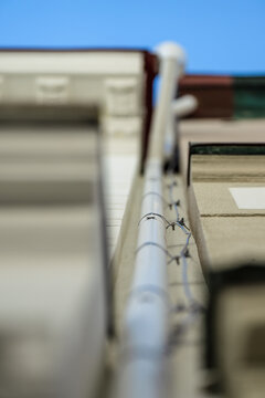 A lightning rod cable bolted to downpipe on a building.