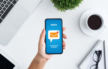 Email marketing and newsletter concept. Top view of unrecognizable young woman holding modern...